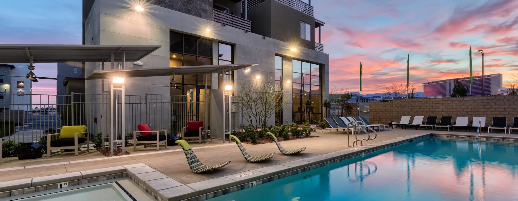 pool showing reclining seating and nearness to property buildings